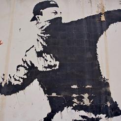 Banksyjevo djelo na zidu koji dijeli Izrael od Palestine - Bacajmo cvijeće, a ne kamenje na druge